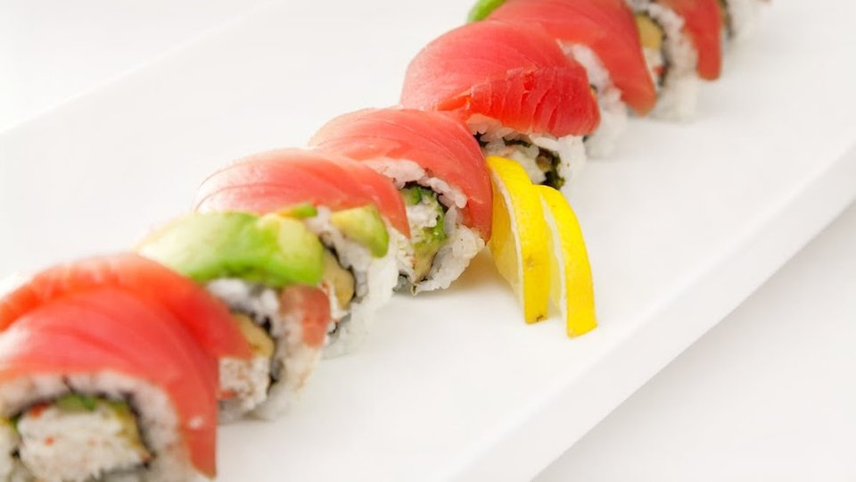 Printed menu with sushi, rolls, and appetizers.